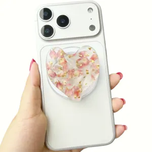Close-up of heart-shaped magnetic phone grip with real dried flowers and gold foil