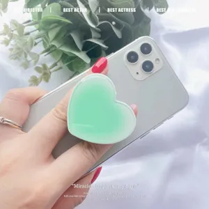 Mint green gradient heart-shaped expanding phone socket grip stand on silver smartphone