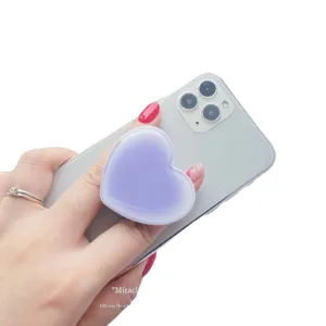 Purple gradient heart-shaped collapsible phone grip stand attached to mobile phone