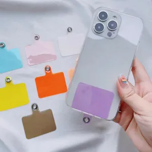 Close-up detail of multi-color phone lanyard patches inside a clear smartphone case