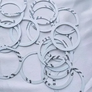 Macro detail view of universal white MagSafe magnetic metal rings with adhesive.