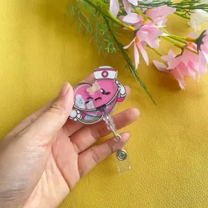 Detailed view of a pink heart cartoon nurse shaker badge reel with retractable clip