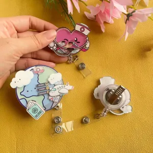 Detailed view of travel and nurse themed shaker retractable badge reels with alligator clips