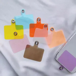 Selection of colorful universal phone lanyard tether tabs on a white textured background