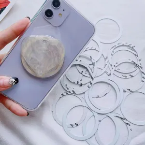 Close-up detail of universal white magnetic rings used for MagSafe phone accessories