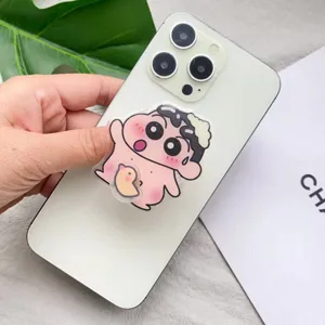 Nahaufnahme eines niedlichen Cartoon-Acryl-Handy-Griffs an einem weißen Smartphone
