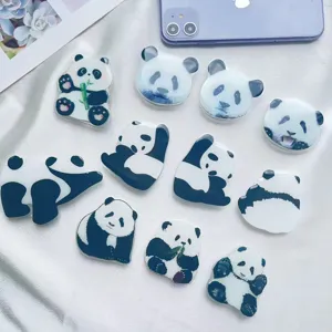 High-quality detail shot of ten various cute acrylic panda pop socket phone grips