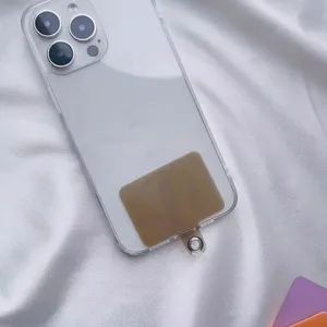 Detail view of a brown universal phone lanyard tether tab inserted inside a clear case