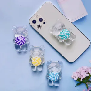 Dettaglio supporto telefono orsetto trasparente con motivo lecca-lecca colorato