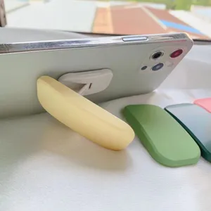 Dettaglio di un supporto per telefono giallo macaron sul retro di uno smartphone