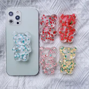 Detailed view of cute bear phone grips with transparent fruit and flower patterns