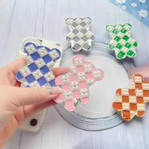 Primo piano dei supporti per telefono orso di perle con trama e colori vivaci