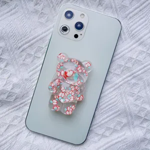 Detail of transparent cute bear phone socket with apple pattern on back of phone