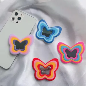 Primer plano de soportes de silicona para móvil con forma de mariposa y espejo integrado