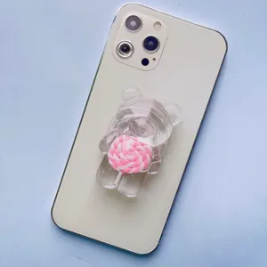 Dettaglio del supporto per telefono a forma di orso trasparente con lecca-lecca rosa