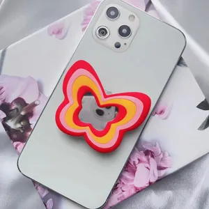 Soporte para móvil de mariposa multicapa con espejo de maquillaje en teléfono blanco