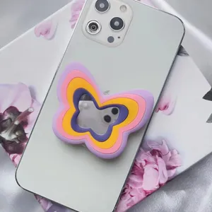 Soporte de silicona multicapa para móvil con forma de mariposa y espejo en smartphone blanco