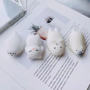 Cute 3D white squishy cartoon animal phone grips on a lifestyle magazine background