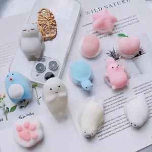 Variety of cute 3D squishy cartoon animal phone socket grips on a background