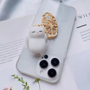 Detailed view of a cute 3D white cat squishy toy airbag phone socket on a clear case