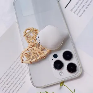 Detailed close-up of a cute white bird-shaped squishy phone grip on a clear case