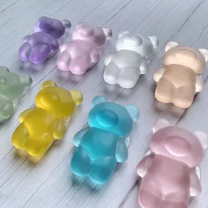 Macro view showing various colorful frosted translucent bear-shaped collapsible phone grips