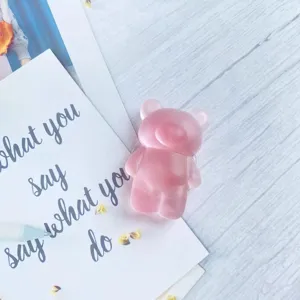Close-up of semi-transparent frosted pink bear-shaped folding phone grip