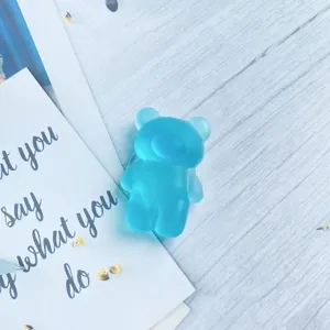 Detailed view of a cute blue frosted semi-transparent bear shaped folding phone grip