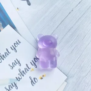 Detailed view of a cute purple semi-transparent matte bear-shaped collapsible phone grip stand