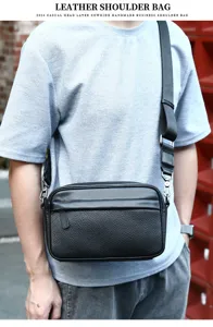 Men's genuine leather crossbody bag detail view, black cowhide shoulder bag with metal hardware.