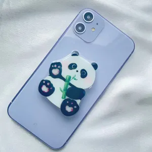 Close-up of cute panda acrylic phone grip with bamboo design on purple phone