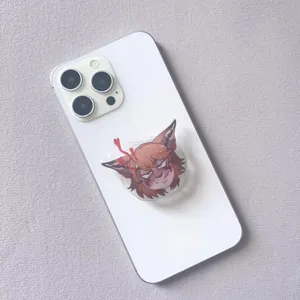 Detailed view of an acrylic cartoon character phone socket grip on a white smartphone