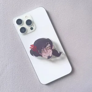 Acrylic cartoon character phone grip stand attached to the back of a smartphone
