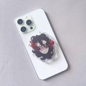 Detailed view of an acrylic cartoon character phone grip on a white smartphone