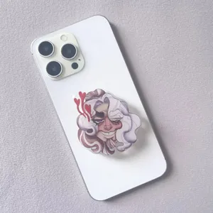 Close-up macro view of cartoon acrylic phone grip with heart details on a white smartphone