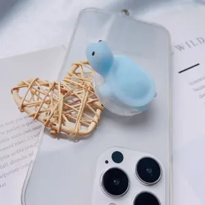 Detail view of 3D cute blue turtle squishy toy on a transparent phone case grip