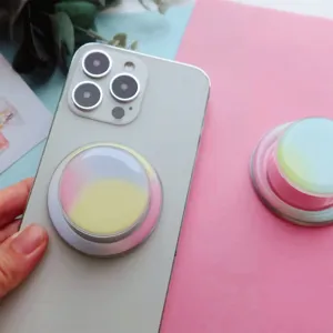 Close-up of a colorful gradient magnetic telescopic phone grip attached to a smartphone
