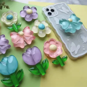 Macro detail view of high-transparency epoxy resin flower and butterfly phone grips