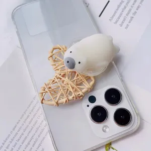 Close-up of a cute 3D polar bear squeeze toy phone grip attached to a clear case