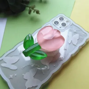 Detailed macro view of clear pink resin tulip flower phone grip on butterfly phone case