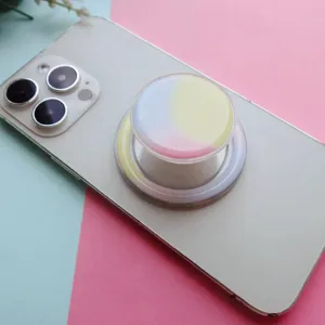 Macro detail of a round pastel gradient expanding phone socket grip on a mobile phone