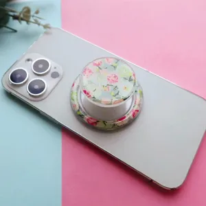 Detailed close-up view of a floral patterned magnetic phone grip attached to a smartphone
