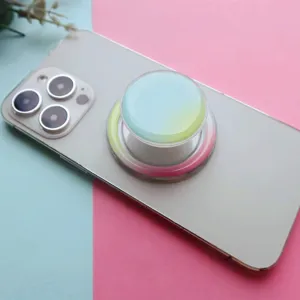 Macro view of gradient round collapsible phone grip stand attached to a smartphone back