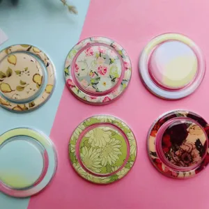 Detailed view of circular magnetic phone stands with various floral and abstract patterns.