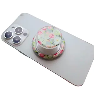 Magnetic phone socket grip with elegant rose floral pattern on a white smartphone