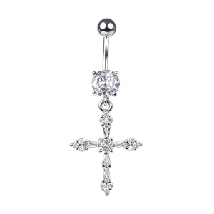 Macro detail of a shiny cross-shaped belly ring with sparkling zircon stones