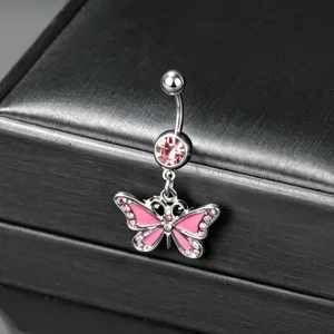 Close-up of silver-toned belly button ring with pink butterfly pendant and small crystals