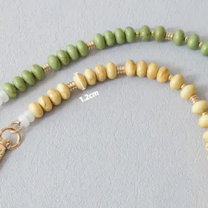 Detailed macro view showing 1.2cm candy-colored acrylic beads with gold metal spacers