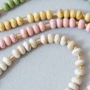 Detailed view of candy-colored acrylic bead chains with marble texture and gold spacers.