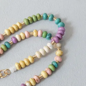 Detail view of vibrant candy-colored acrylic beads and gold-toned spacers on a stylish chain
